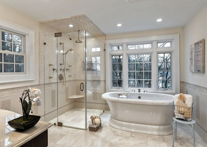 A bathroom with a large tub and shower.