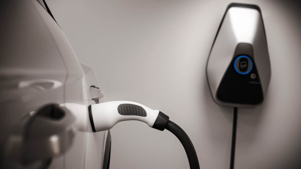 A close up of an electric car charger plugged in